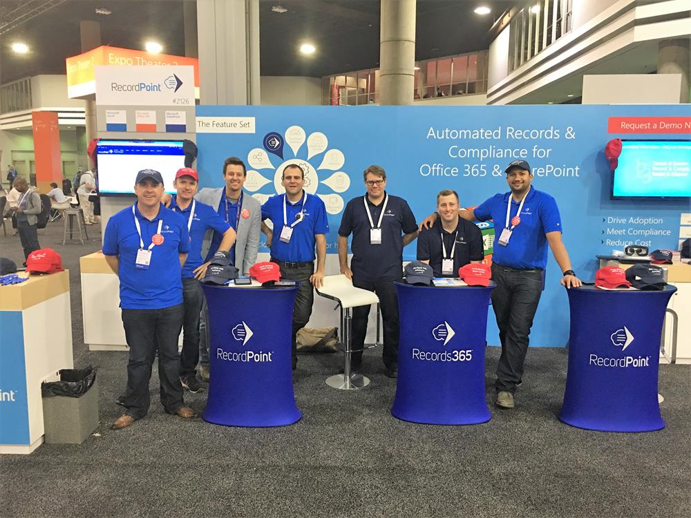 Customer photo from Aaron of our Bic Grip Rollerball Pen - Nickel Clip, a group of people standing in front of a blue wall